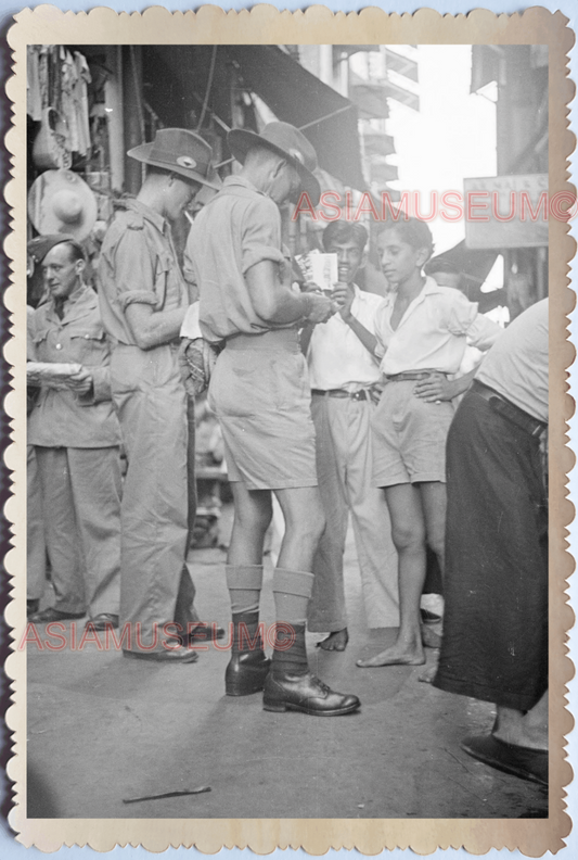 WW2 STREET SCENE BOY SELL POSTCARD MILITARY POLICE Vintage Singapore Photo 18703